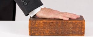 Hand on Bible iStock 000032381100Small 670x270