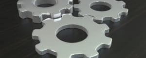 Business composition with metal gears on dark wooden tabletop